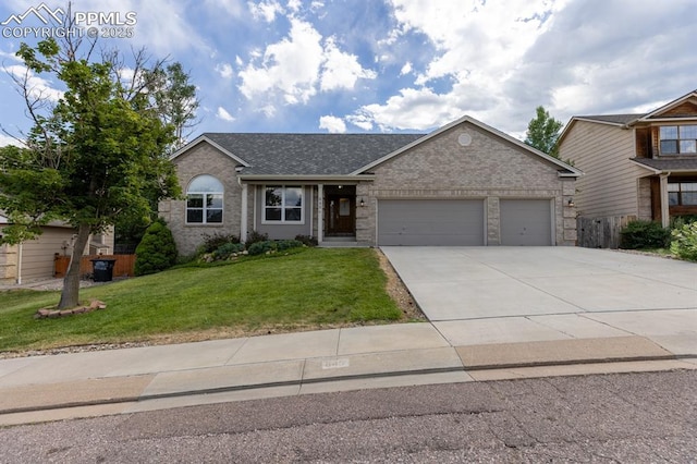 view of front of property featuring a garage and a front yard