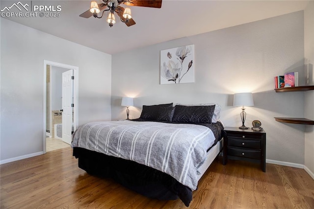 bedroom featuring ceiling fan, light wood-type flooring, and connected bathroom