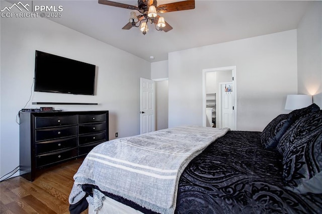 bedroom with ceiling fan, dark wood-type flooring, and ensuite bath