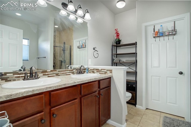 bathroom featuring vanity, a shower, tile patterned flooring, toilet, and tasteful backsplash