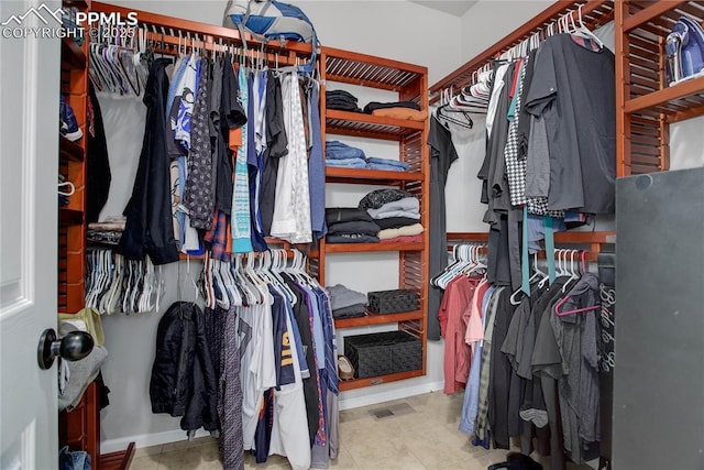 walk in closet featuring light tile patterned floors