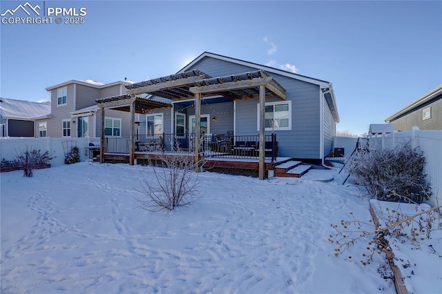 snow covered property with a pergola