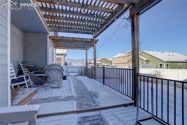 snow covered deck featuring a pergola