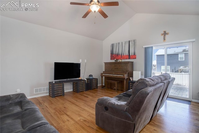 living room featuring hardwood / wood-style flooring, high vaulted ceiling, and ceiling fan