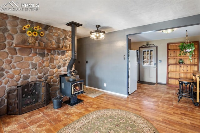 living room with hardwood / wood-style flooring and a wood stove