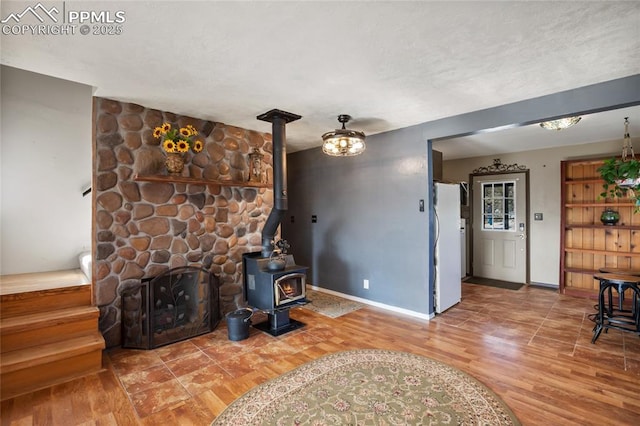 living room with hardwood / wood-style flooring and a wood stove