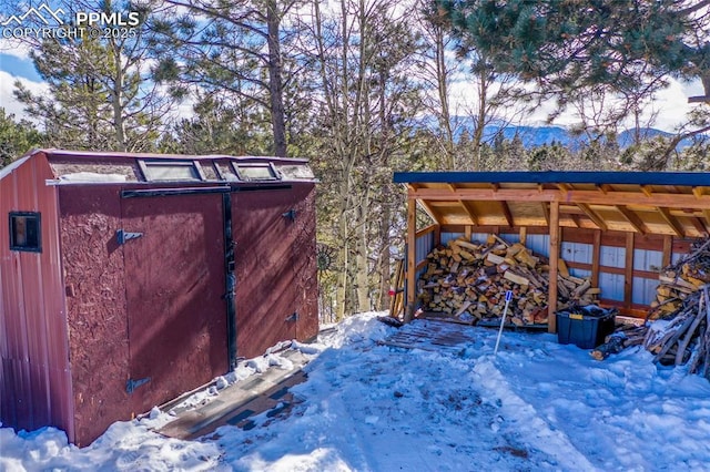 snow covered deck with an outdoor structure