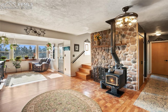 living room with wood-type flooring and a wood stove