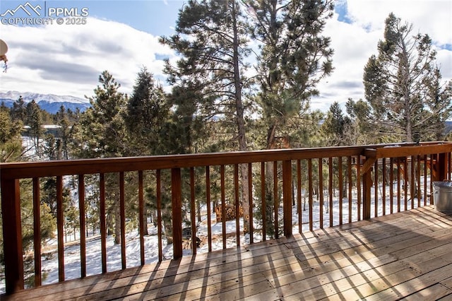 snow covered deck featuring a mountain view