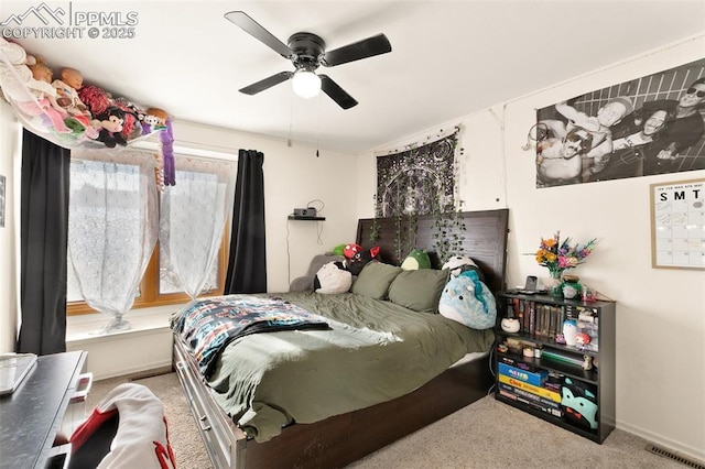 carpeted bedroom featuring ceiling fan and multiple windows