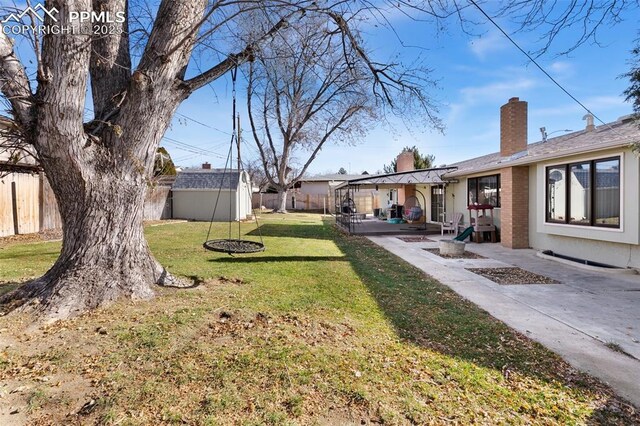 view of yard with a patio area and a shed