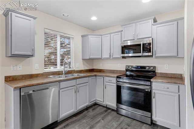 kitchen featuring sink, wood-type flooring, and appliances with stainless steel finishes