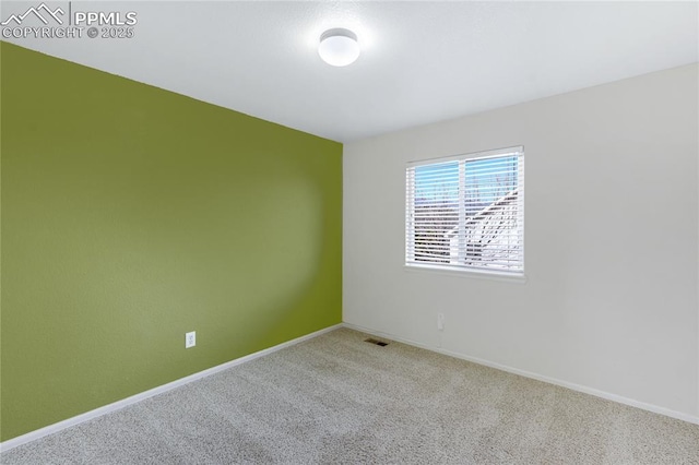 unfurnished room with light colored carpet