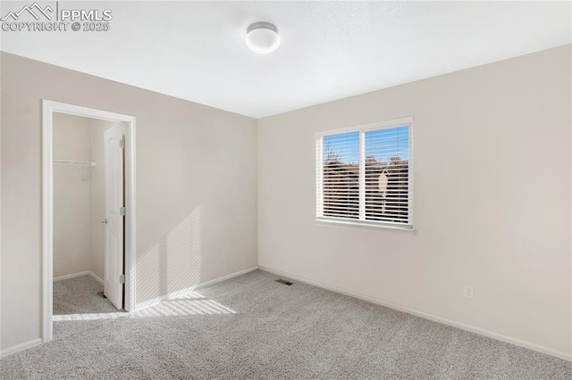 unfurnished room featuring light carpet