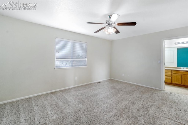 carpeted empty room with ceiling fan and sink