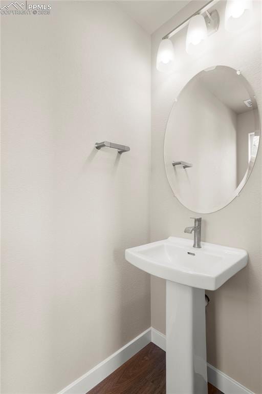 bathroom with hardwood / wood-style floors and sink