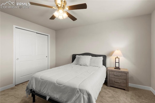 bedroom with ceiling fan, a closet, and light carpet