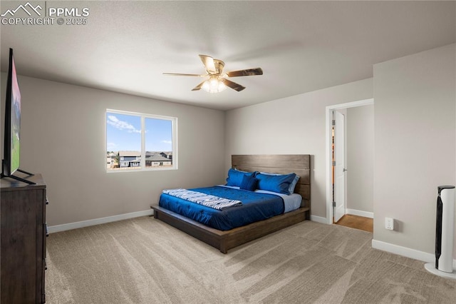 bedroom featuring ceiling fan and light carpet