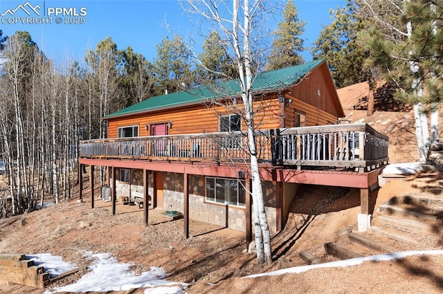 rear view of property featuring a deck