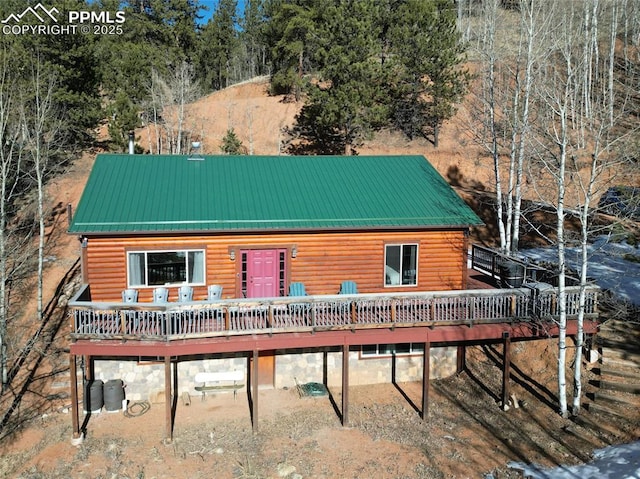 back of property with a wooden deck