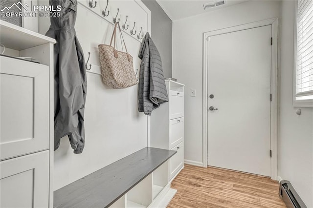 mudroom with baseboard heating, a healthy amount of sunlight, and light wood-type flooring