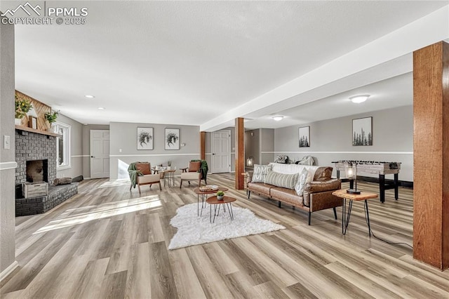 living room with a fireplace and light hardwood / wood-style floors