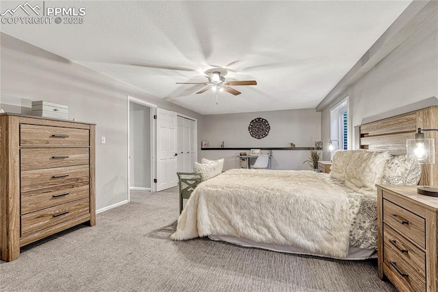 carpeted bedroom featuring ceiling fan and a closet