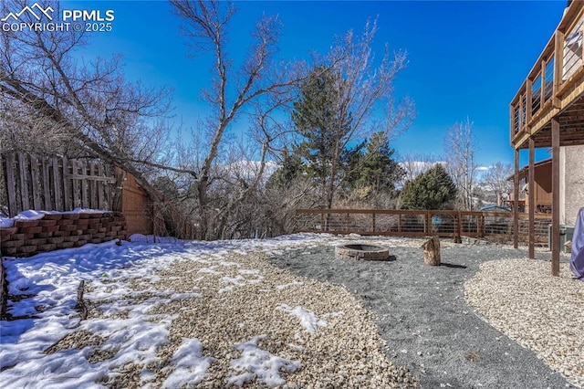 snowy yard featuring a fire pit