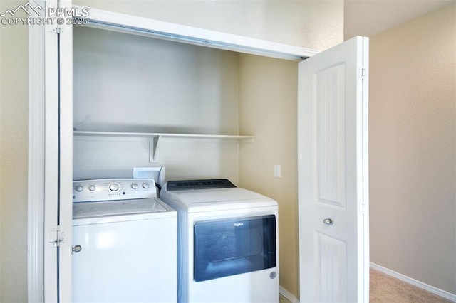 clothes washing area featuring washer and dryer and light carpet