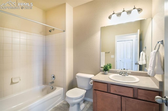 full bathroom with vanity, toilet, and tiled shower / bath