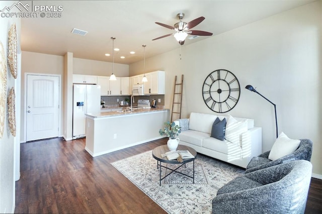 living room featuring ceiling fan, dark hardwood / wood-style flooring, and sink