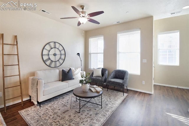 living room featuring ceiling fan and dark hardwood / wood-style floors