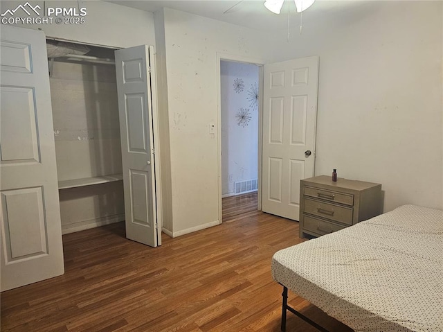 bedroom with dark hardwood / wood-style floors