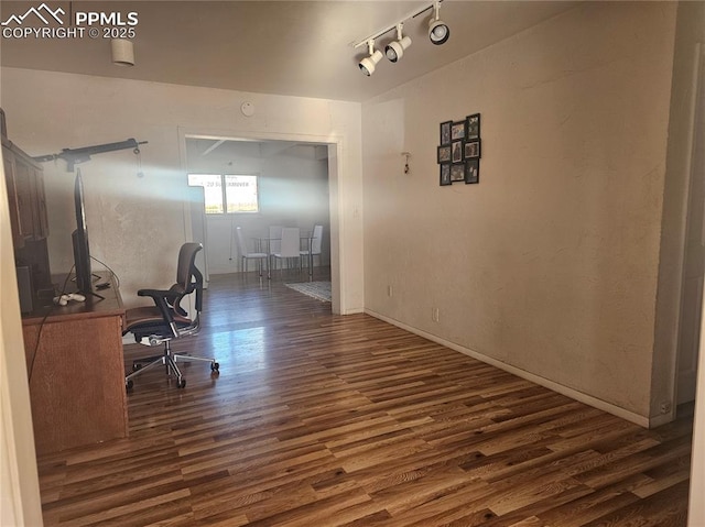 office area with track lighting and dark hardwood / wood-style floors