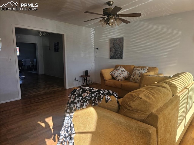 living room featuring wood-type flooring and ceiling fan