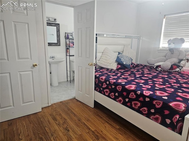 bedroom with sink and hardwood / wood-style flooring