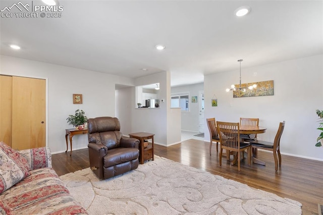 living room featuring dark hardwood / wood-style flooring and a chandelier