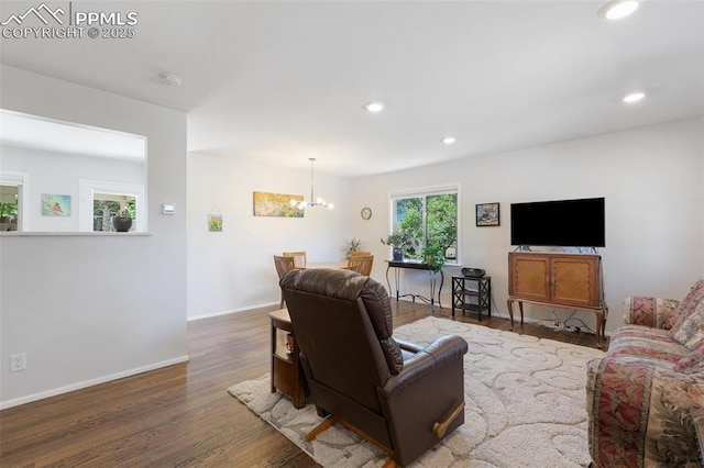 living room featuring hardwood / wood-style floors and an inviting chandelier