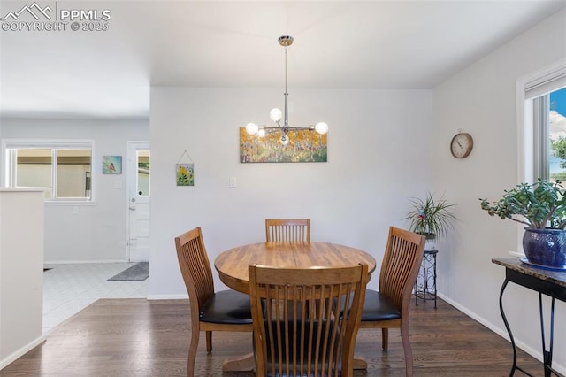 dining space featuring dark hardwood / wood-style floors and a chandelier