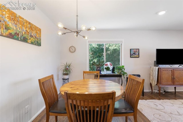 dining space with a chandelier and dark hardwood / wood-style flooring