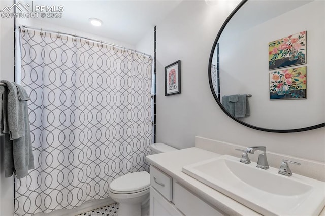 bathroom with walk in shower, tile patterned flooring, vanity, and toilet