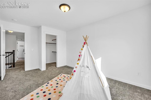 bedroom featuring carpet, a spacious closet, and a closet