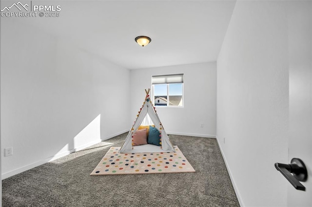 recreation room featuring dark colored carpet