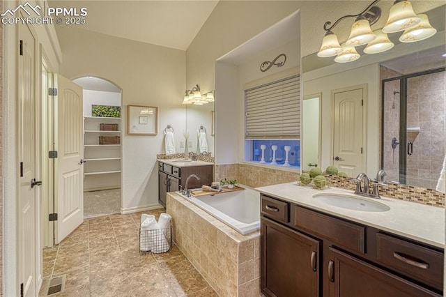 bathroom featuring vanity and independent shower and bath