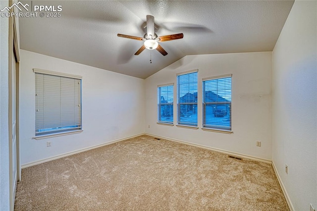 spare room with light carpet, ceiling fan, and lofted ceiling