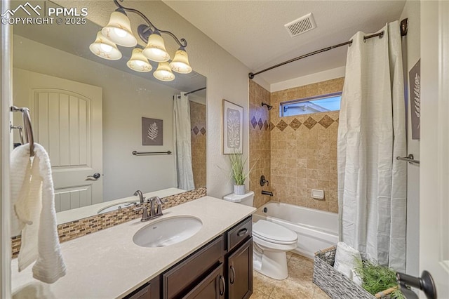 full bathroom featuring shower / bath combo, a notable chandelier, a textured ceiling, toilet, and vanity