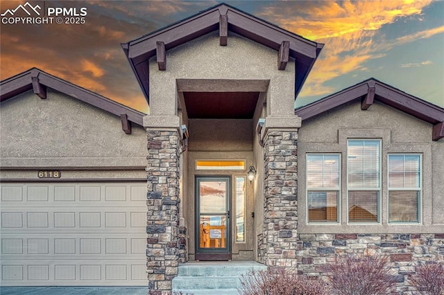 exterior entry at dusk with a garage