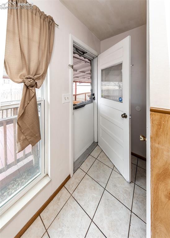 doorway featuring light tile patterned flooring