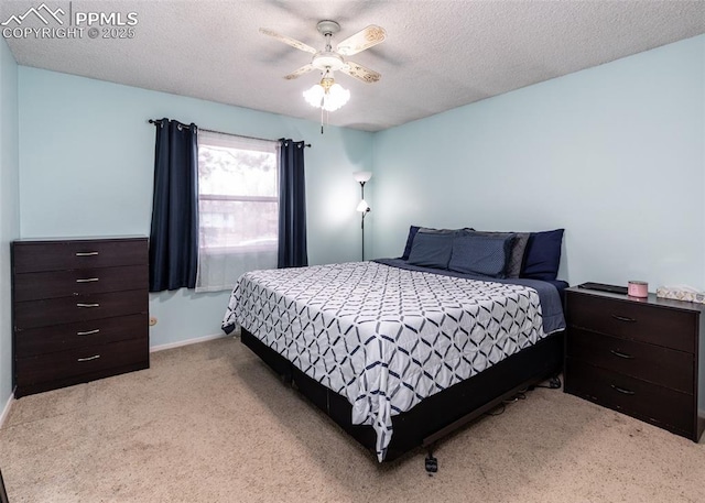 carpeted bedroom with ceiling fan and a textured ceiling