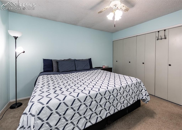 carpeted bedroom with ceiling fan, a closet, and a textured ceiling